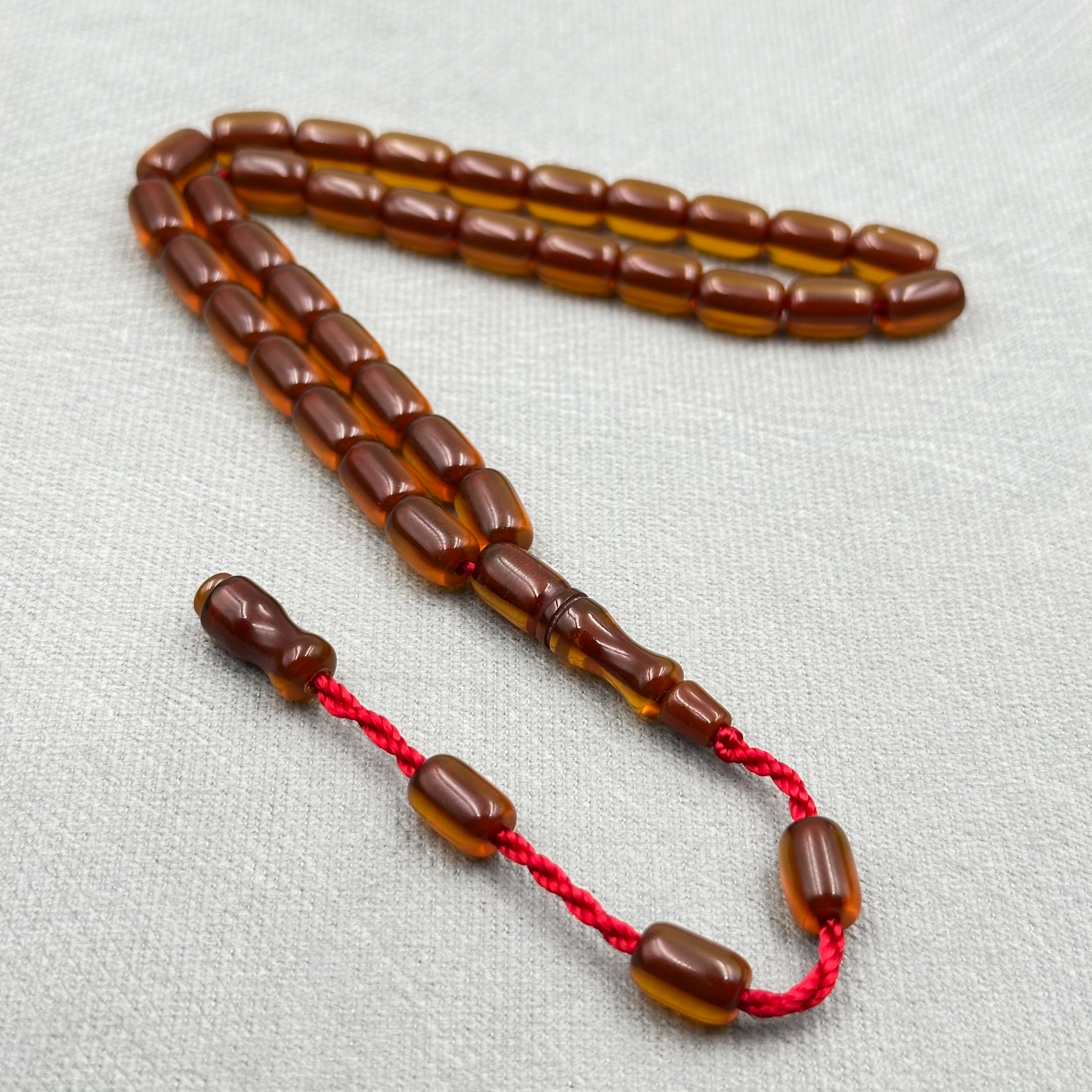 Koyu Amber Tonlu Parlak Kapsül Kesim Sıkma Kehribar Tespih